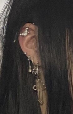 the back of a woman's head with ear piercings