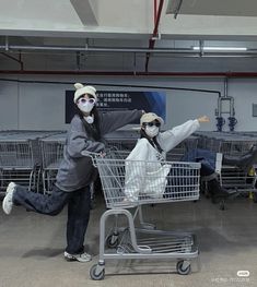 two people in animal costumes are pushing a shopping cart with their legs spread out to the side