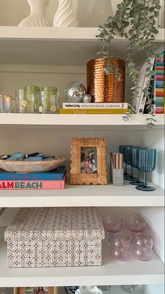 the shelves are filled with books, vases and other decorative items on top of them