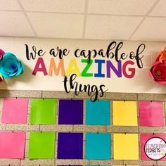 we are capable of amazing things bulletin board with colorful tiles and paper flowers on the wall