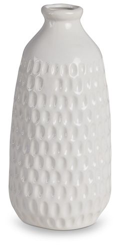 a white vase with holes in the middle