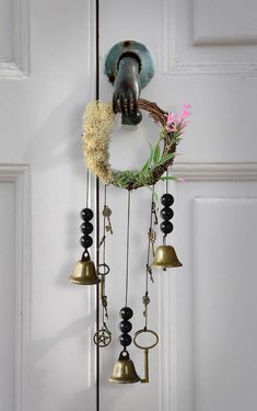 a door with bells and flowers hanging from it