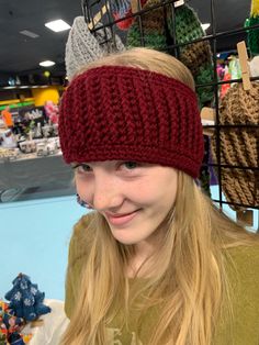 a woman wearing a knitted headband in a store