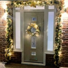 a door decorated with wreaths and lights