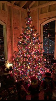 a brightly lit christmas tree in a living room