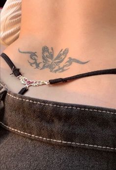 a woman with a butterfly tattoo on her lower back and the bottom part of her stomach