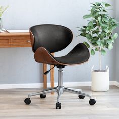 an office chair next to a potted plant