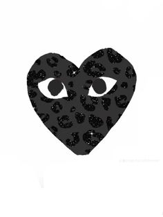 an animal print heart with two eyes and black leopard spots on it's face