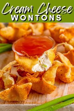 a wooden cutting board topped with cheesy wontons and ketchup