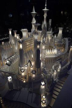 a model of a castle lit up at night with lots of lights on the top