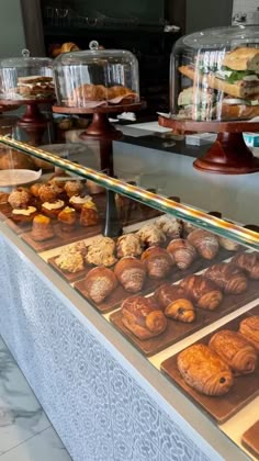 an assortment of baked goods on display in a bakery