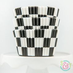 black and white checkered cups sitting on top of each other