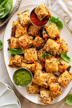 a white plate topped with tofu covered in sauce and garnished with green leaves