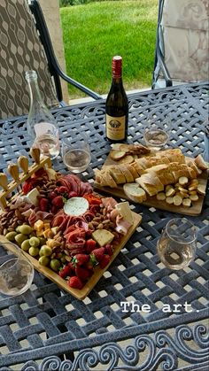 an assortment of food and wine on a table