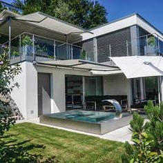 a large white house with a hot tub in the yard