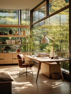 a home office with large windows and lots of natural light coming in from the floor to ceiling windows