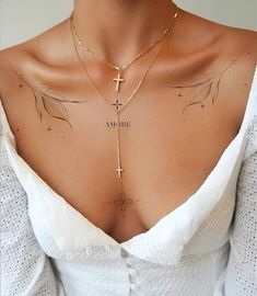 a woman wearing a cross necklace with the word jesus written on it's chest