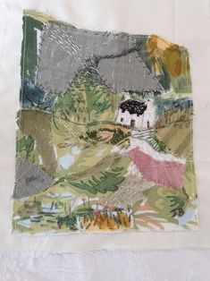 a piece of fabric with an image of a house and trees in the distance on it