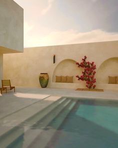 an indoor swimming pool with chairs and vases