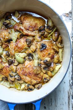 chicken with artichokes in mushroom - sherry sauce is shown in a skillet