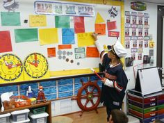 a woman in a chef's hat writing on a white board