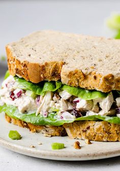 a white plate topped with a chicken salad sandwich