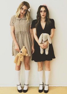 two young women standing next to each other with stuffed animals in front of their faces