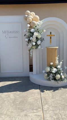 a white church with flowers and a cross