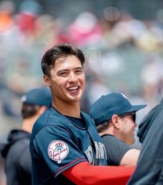 a baseball player is smiling at the camera