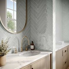 a bathroom with marble counter tops and wooden cabinets, along with a round mirror on the wall