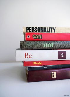 black and white photograph of books stacked on top of each other with the words personality printed on them