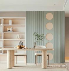 a dining room with a table and chairs in front of a book shelf filled with books