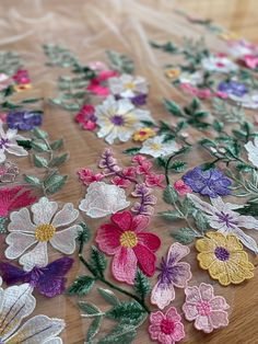 an image of some flowers on a table cloth that is being sewned onto