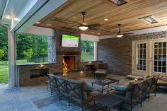 an outdoor living area with fireplace and seating