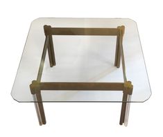 a glass table with two wooden legs and a square shaped glass tabletop on top