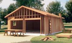 a wooden shed with picnic tables and benches