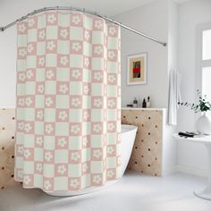 a bathroom with a checkered shower curtain and white bathtub in front of a window