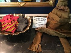 two bowls with gloves and a sign on them