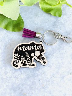 a keychain with the word mama on it and an elephant charm attached to it