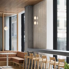 an empty restaurant with wooden tables and chairs