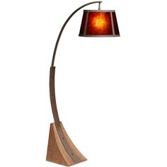 a lamp that is on top of a wooden base and has a red glass shade