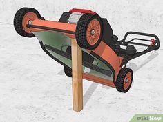 an orange and black toy car sitting on top of a wooden pole in the snow