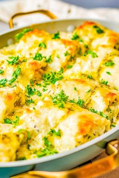 a casserole dish with cheese and parsley