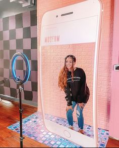 a woman taking a selfie in front of a mirror with her hands on her hips