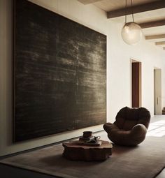 a living room with a large chalkboard on the wall next to a coffee table