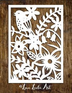 a paper cutout with flowers and birds on it