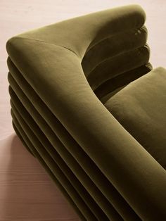 a stack of green couches sitting on top of a wooden table