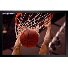 a man dunking a basketball into the hoop with his hands and feet in midair