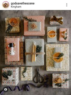 christmas presents are laid out on the floor with oranges and pine cones in them