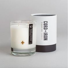 a white candle sitting next to a box